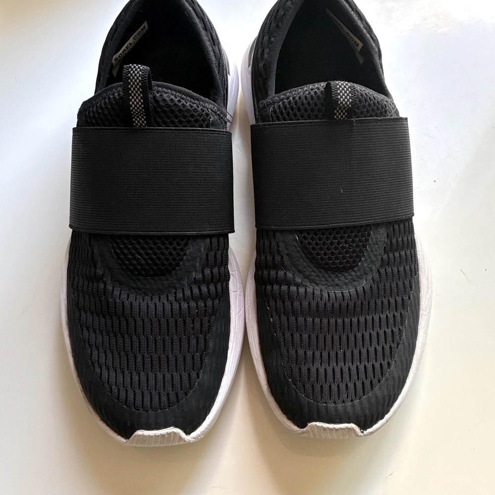 Sorel Women’s Kinetic Impact, Black and White Slip-On Sneakers